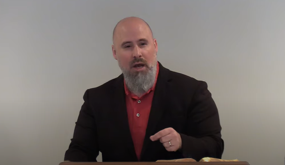 two man and woman standing on doorway